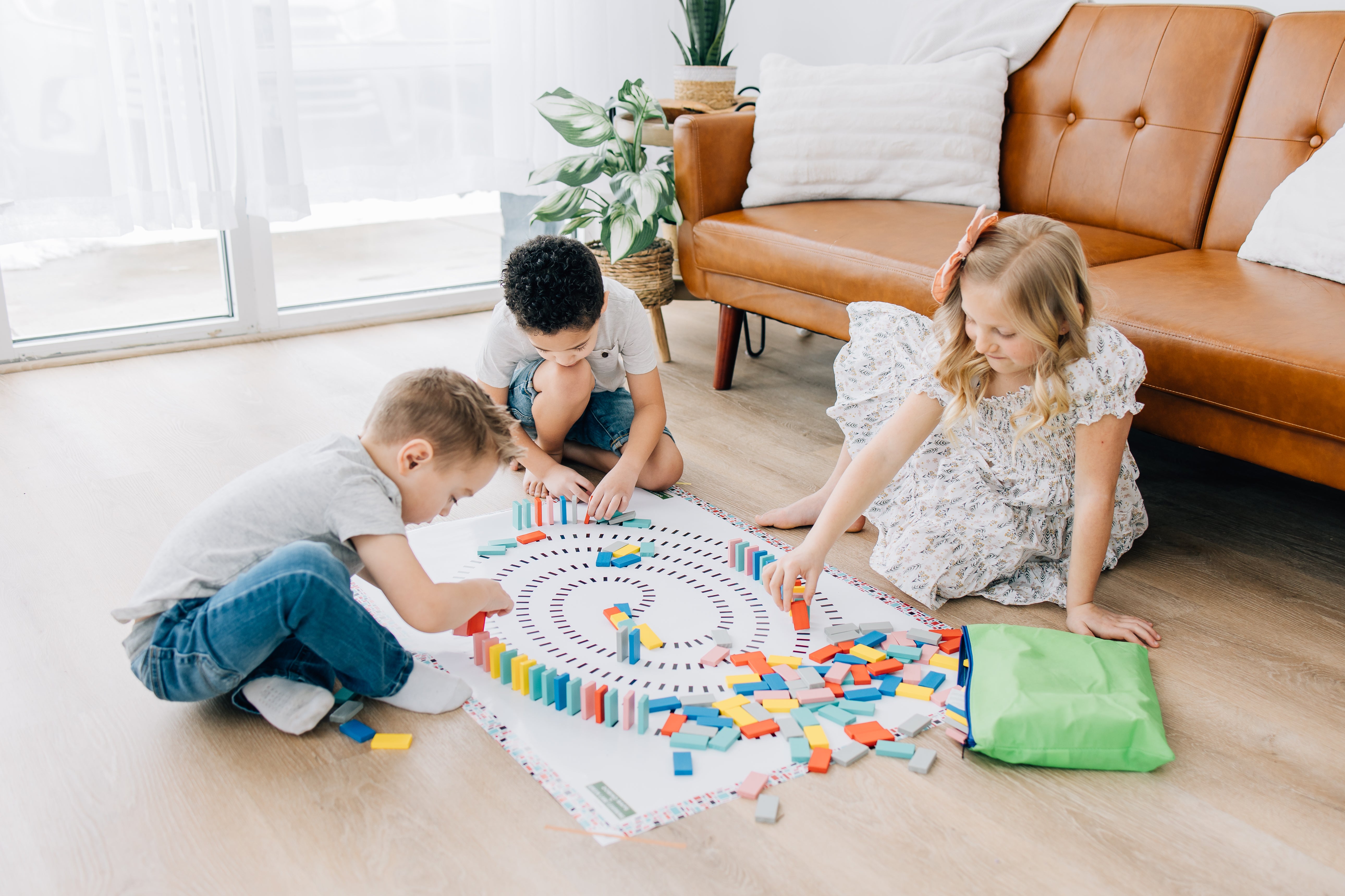Children playing on the floor with spiral domino map